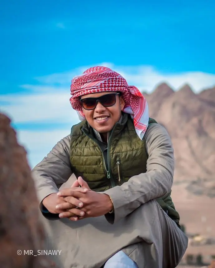 Smiling Bedouin guide ready to share stories and lead unforgettable hiking experiences in Sinai
