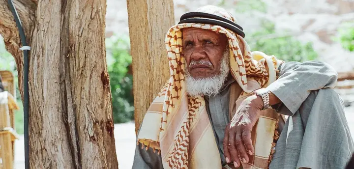 Top 10 things to do in Sinai in 2025 Portrait of Dr. Ahmed Mansour, a respected elder and herbalist from the Gebalia tribe, sitting among native plants in his mountain herb garden in Saint Catherine, surrounded by the tools and herbs of his traditional Bedouin practice.