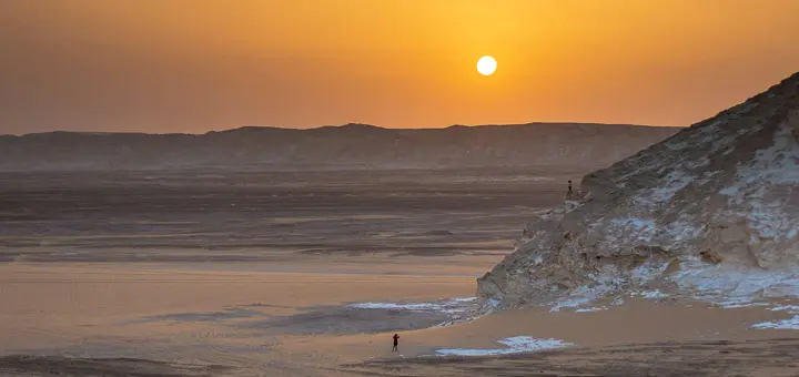 Golden sand dunes at sunset with mountains in the background, Bahariya Oasis, Egypt's Western Desert and Eastern Desert region.