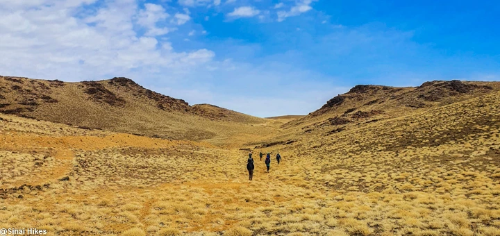 Hikers trekking along the trail of Mount Abu Rumeil in the Sinai Mountains.