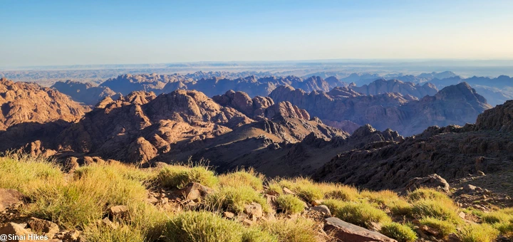 Morning view of the Sinai Mountains with sunlight reaching the rocky peaks and valleys.